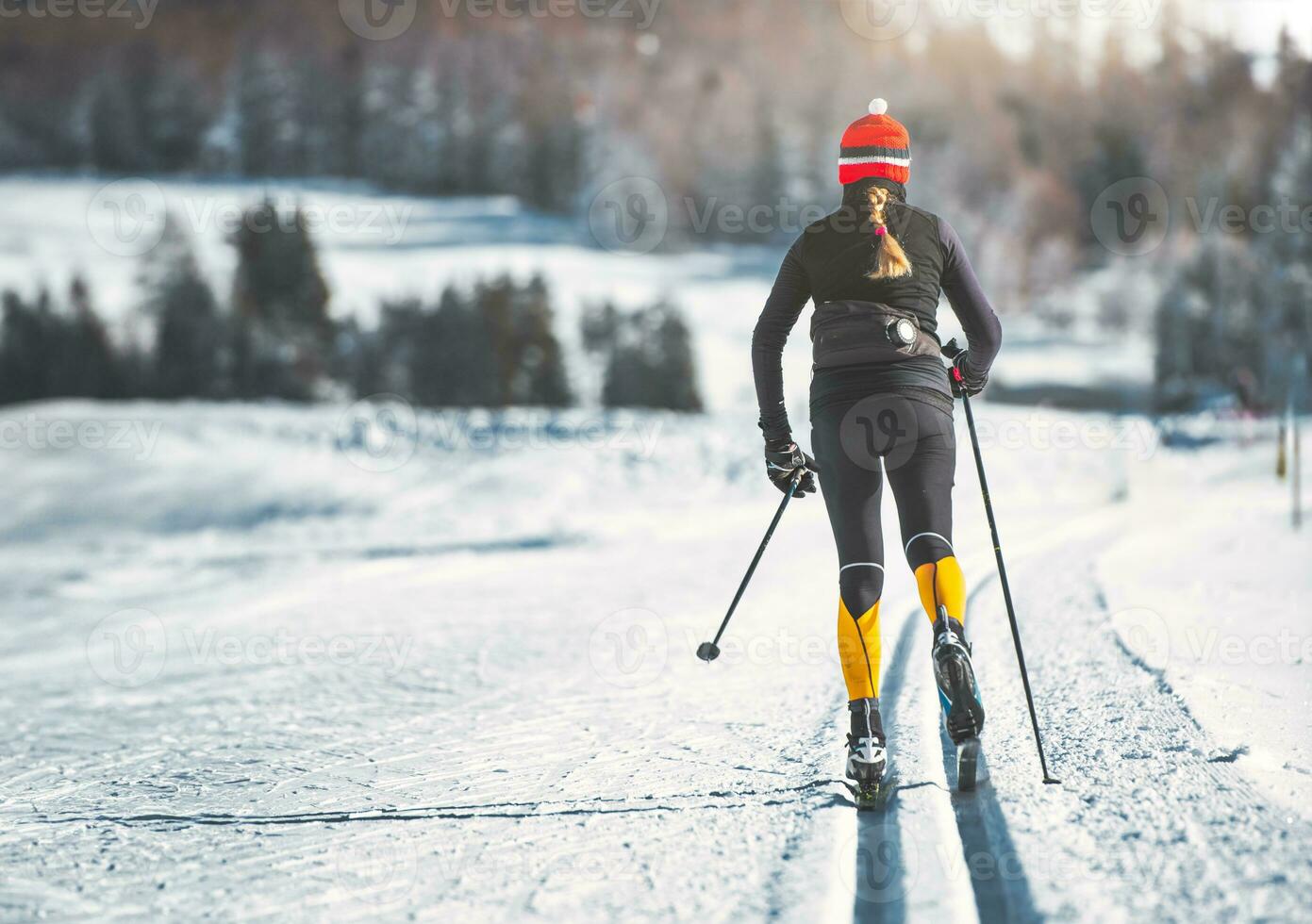 Young woman practices cross-country skiing photo