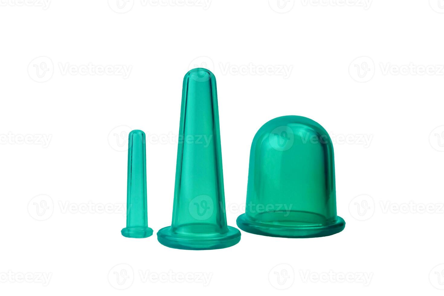 Three green silicone vacuum massage jars of different sizes on a white background. Anti-cellulite silicone vacuum body jars. Home massage. Isolation. Rejuvenation concept. photo