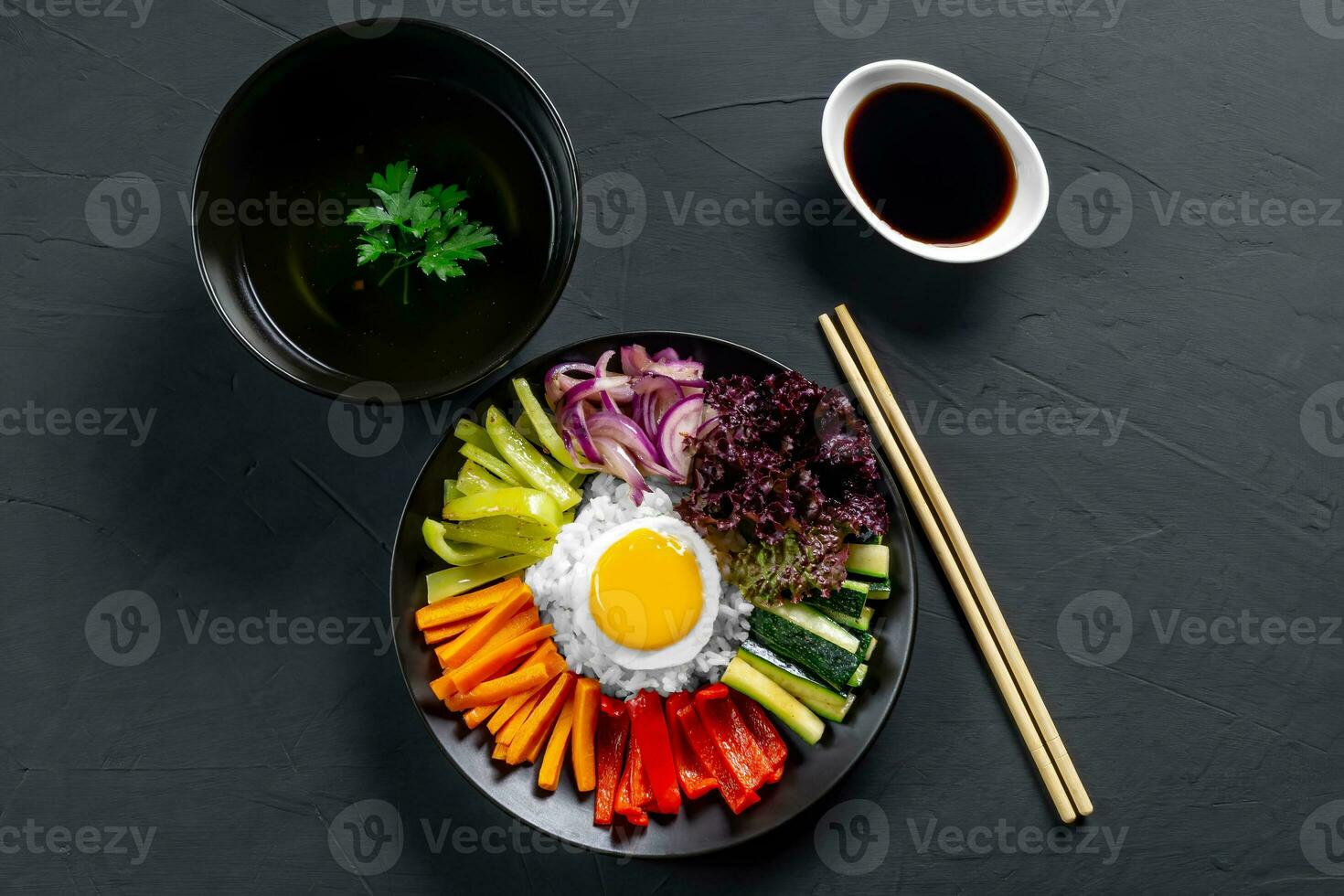 Korean dish, with a variety of appetizers with vegetables and eggs. Diet. bibimbap. Top view. Round plate. photo