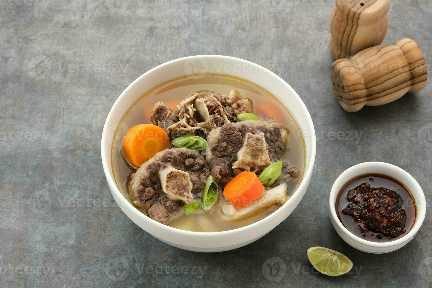 Sop Buntut or Oxtail Soup with carrot and potatoes. Indonesian traditional food photo