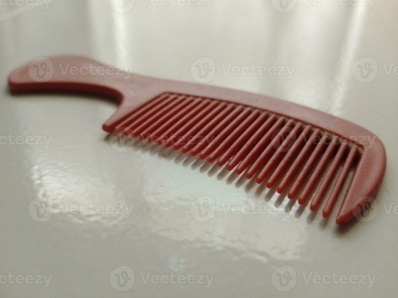 31 August 2023, small red comb to tidy up hair photo