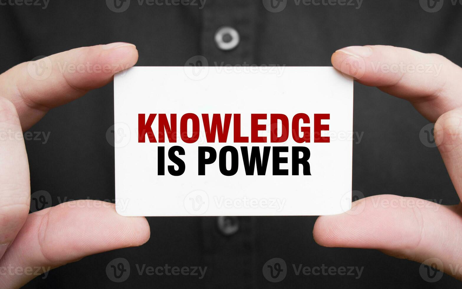 Businessman holding a card with text KNOWLEDGE IS POWER, business concept photo