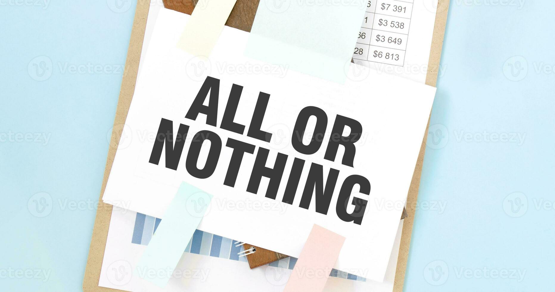 Paper plate with text take ALL OR NOTHING. Diagram, notepad and blue background photo
