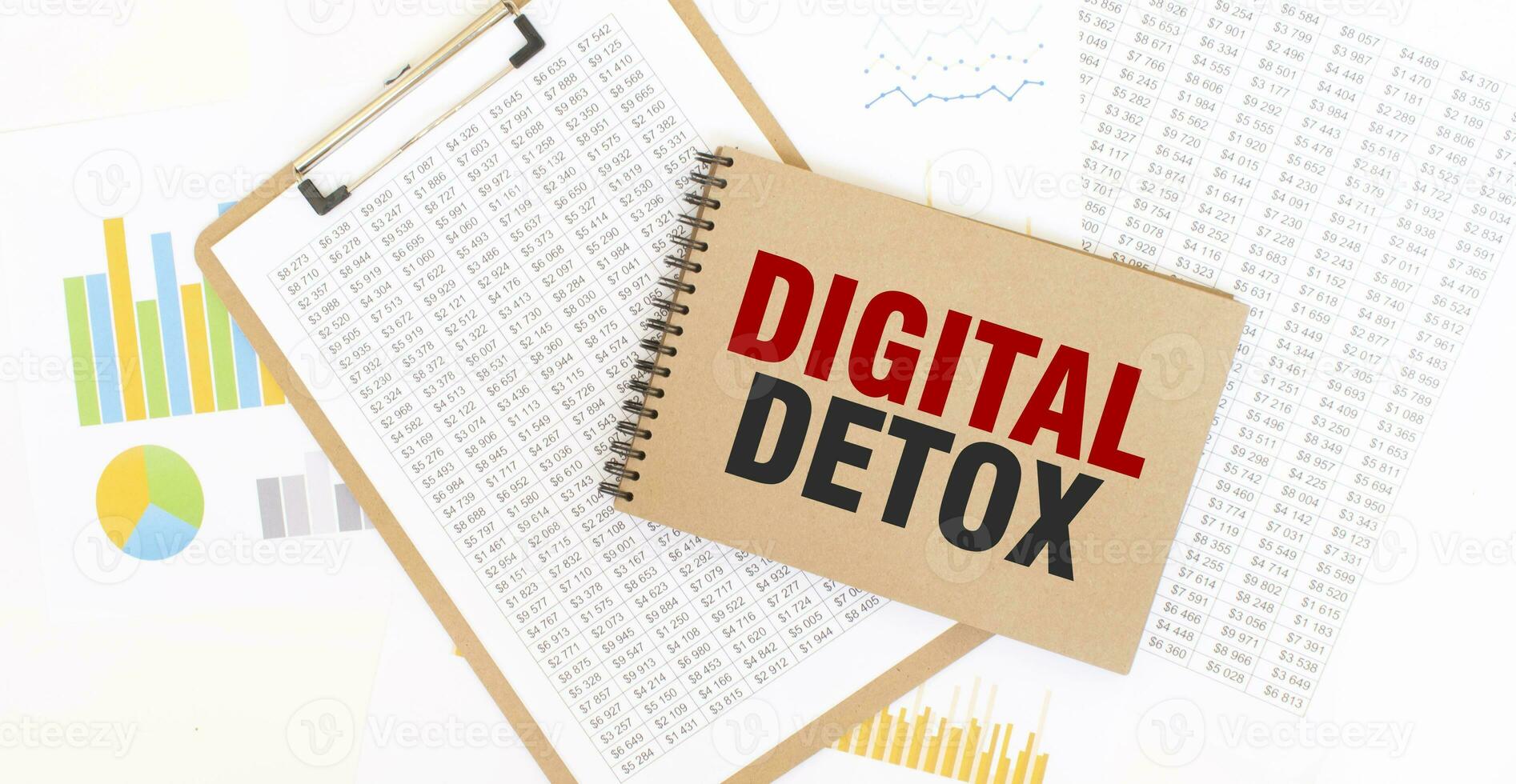 Text DIGITAL DETOX on brown paper notepad on the table with diagram. Business concept photo