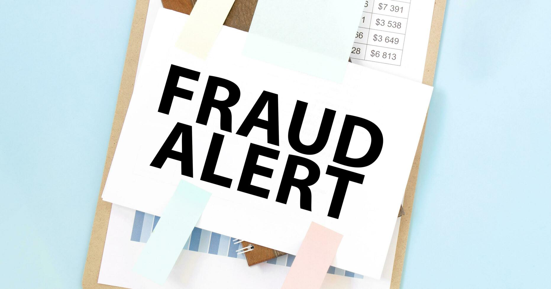 Paper plate with text take fraud alert. Diagram, notepad and blue background photo