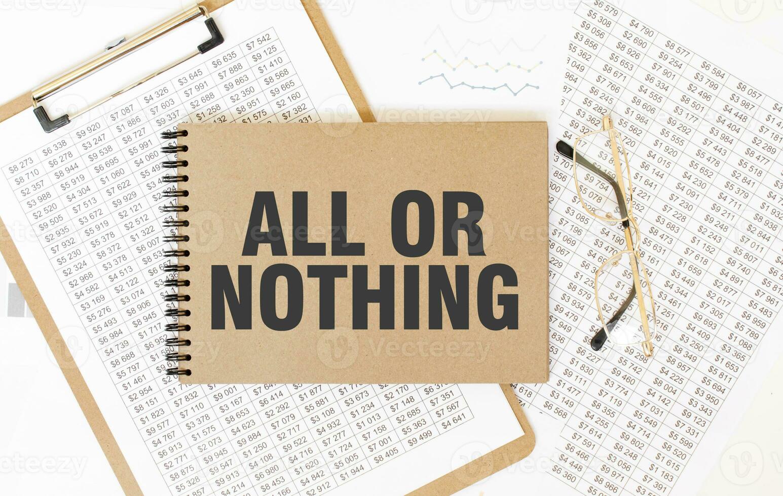 Craft colour notepad with text ALL OR NOTHING. Notepad with eyeglasses and text documents. Business concept photo