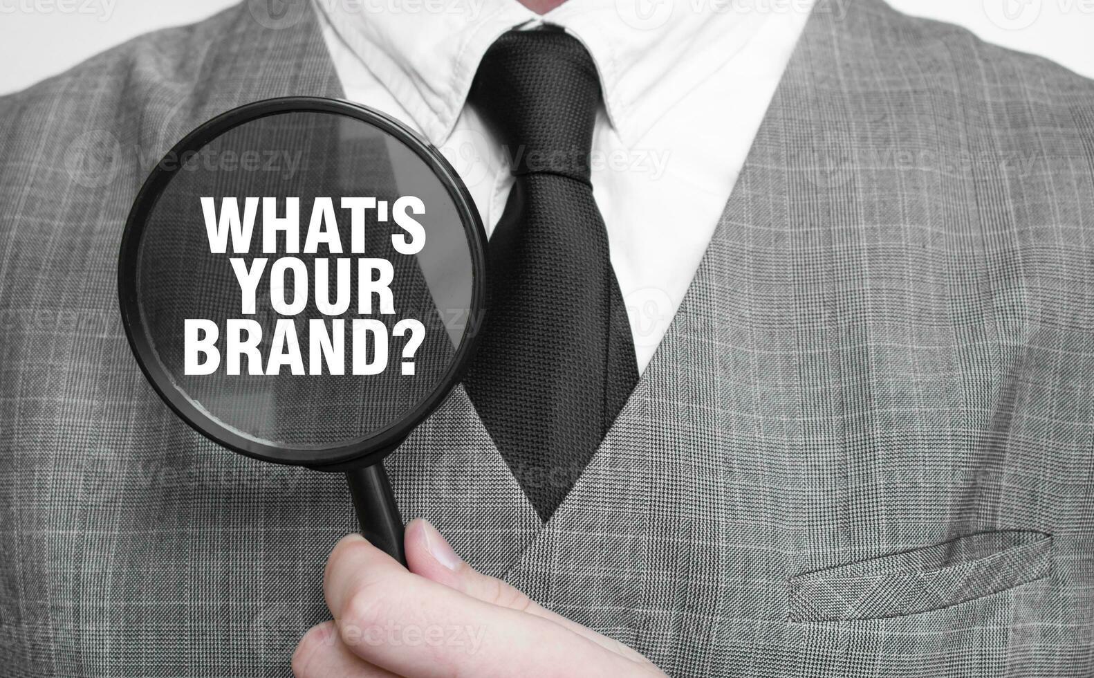 WHAT's your brand word on magnifying glass and hand photo