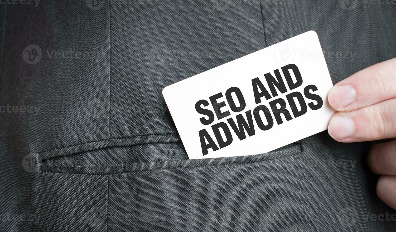 Card with SEO AND ADWORDS text in pocket of businessman suit. Investment and decisions business concept. photo