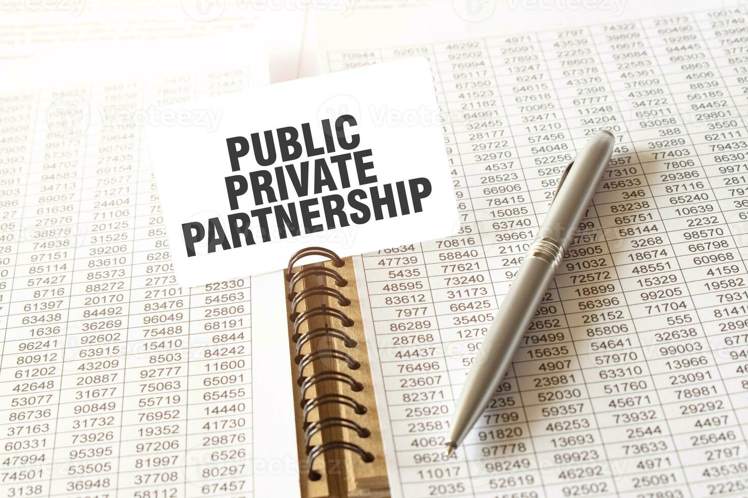 Text PUBLIC PRIVATE PARTNERSHIP on paper card, pen, financial documentation on table photo