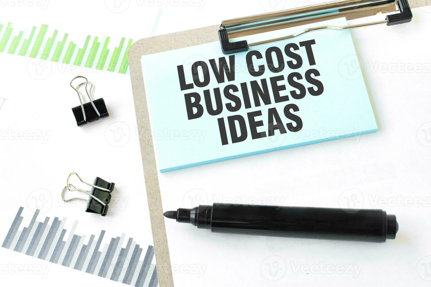 Paper plate, marker, diagram, chart and office tools. Text LOW COST BUSINESS IDEAS photo