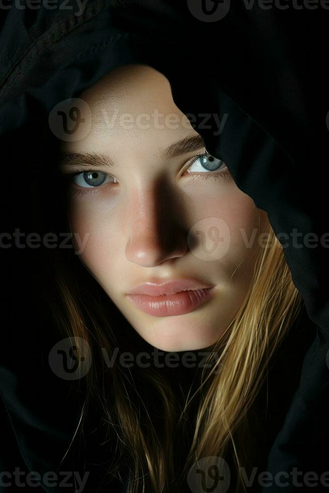 a beautiful young woman with blue eyes is wearing a black hood generative ai photo
