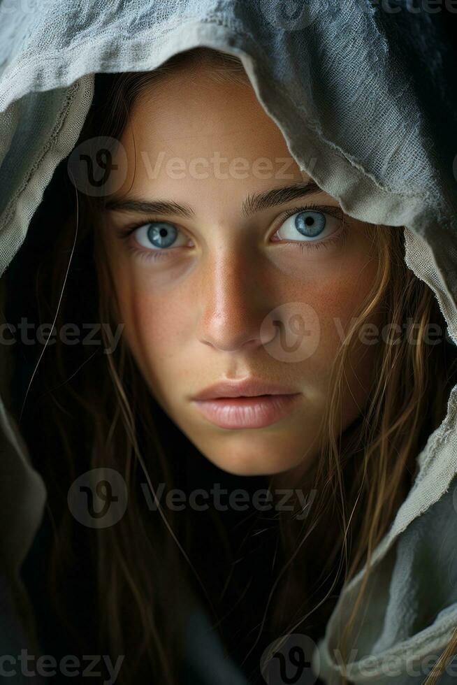 a young woman with blue eyes under a hood generative ai photo