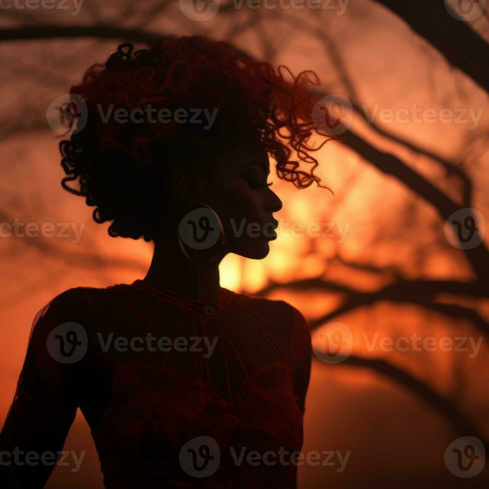 silhouette of a woman with red hair in front of a tree at sunset generative ai photo