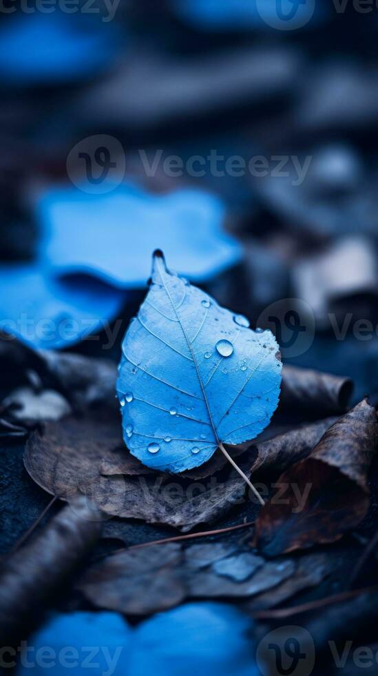 a blue leaf laying on the ground with water droplets on it generative ai photo