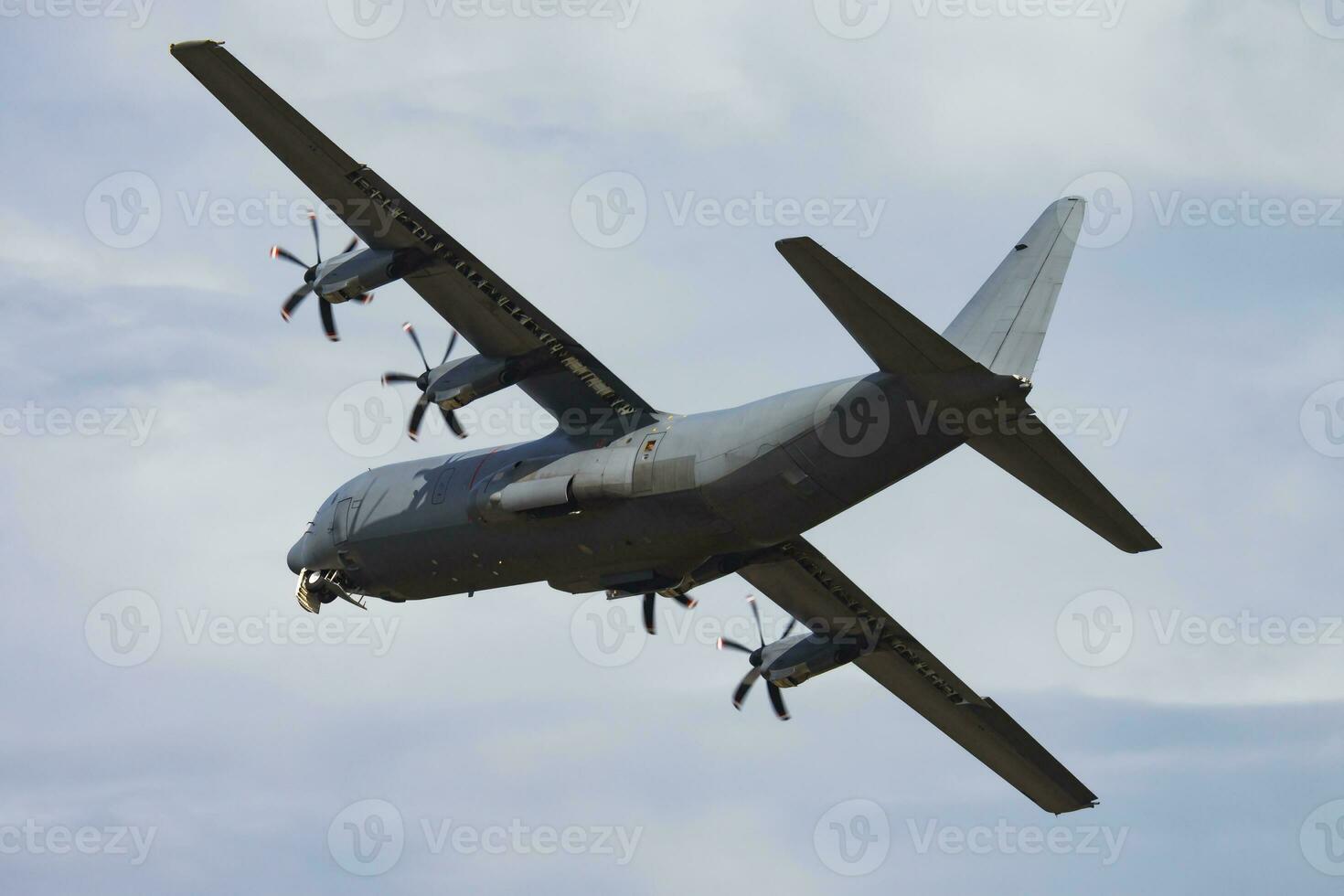 Untitled military transport plane at air base. Airport and airfield. Air force and army flight operation. Aviation and aircraft. Air lift. Military industry. Fly and flying. photo