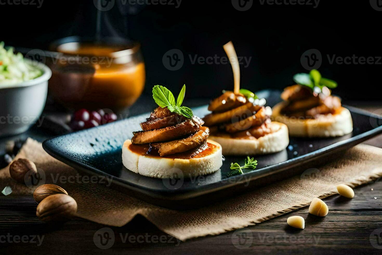 small appetizers on a black plate with sauce. AI-Generated photo