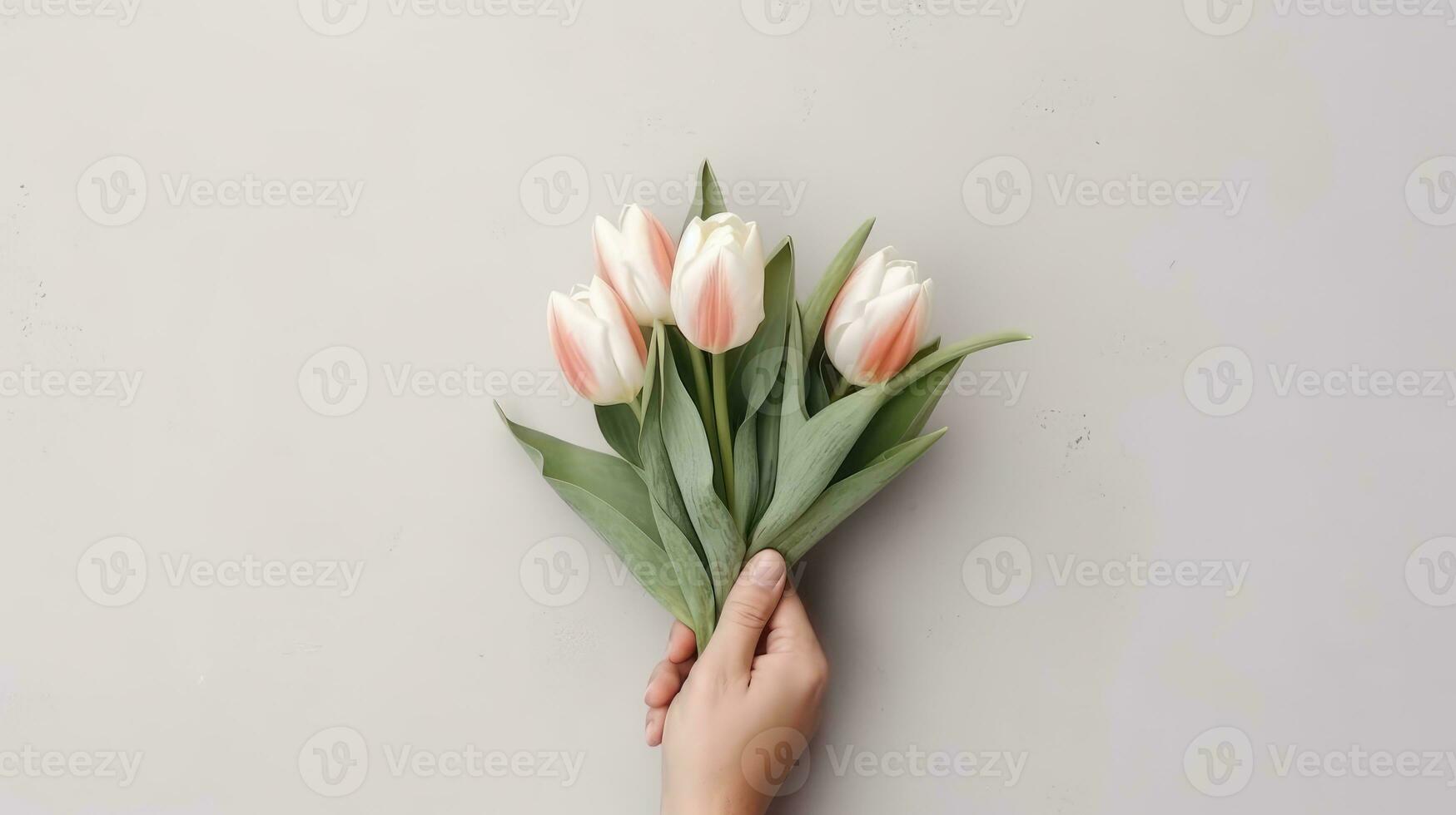 Hand holding a beautiful bouquet of tulip flowers. Isolated on a light wall background. AI Generated photo