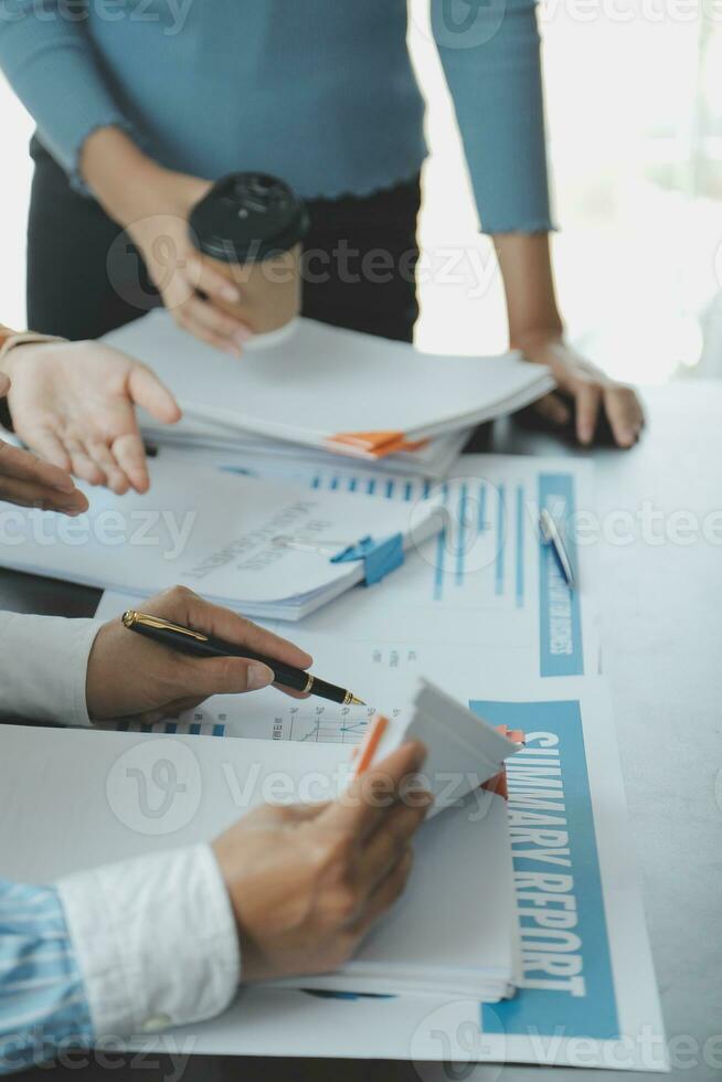 Financial analysts analyze business financial reports on a digital tablet planning investment project during a discussion at a meeting of corporate showing the results of their successful teamwork. photo