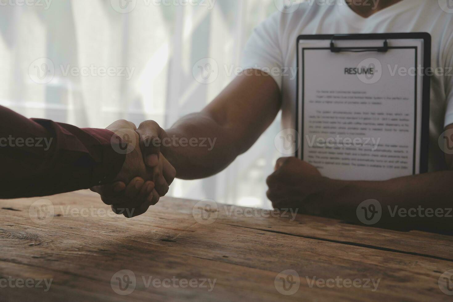 Close up view of job interview in office, focus on resume writing tips, employer reviewing good cv of prepared skilled applicant, recruiter considering application, hr manager making hiring decision photo