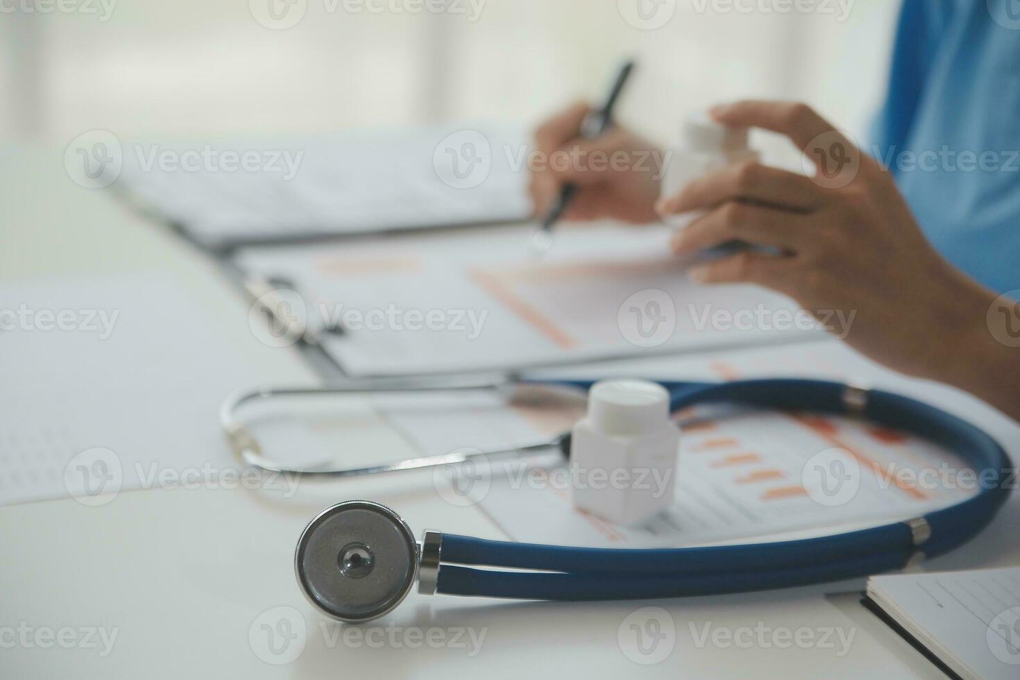 Stethoscope and background doctor using laptop at desk in clinic working on computer at room office. photo