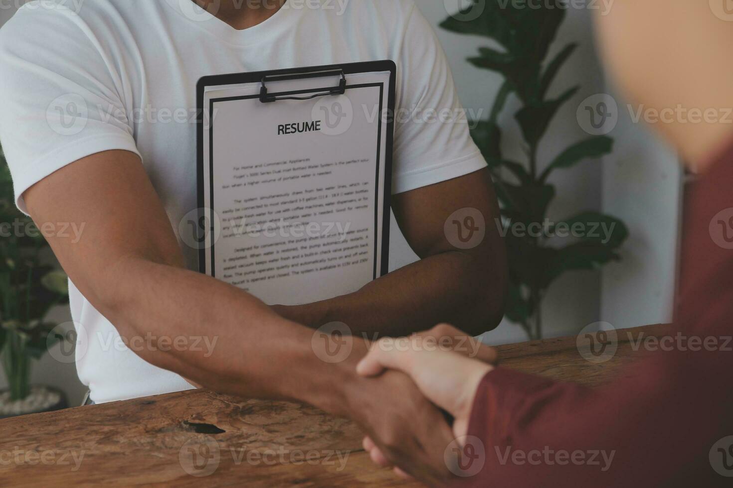 Close up view of job interview in office, focus on resume writing tips, employer reviewing good cv of prepared skilled applicant, recruiter considering application, hr manager making hiring decision photo