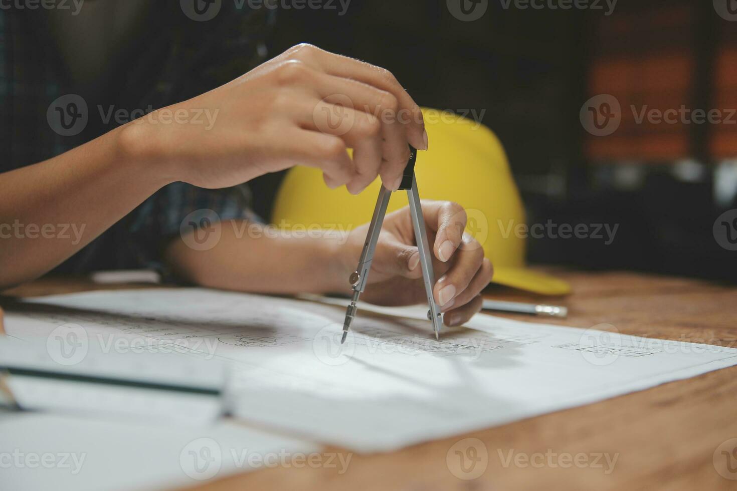 Team of multiethnic architects working on construction plans in meeting room. Engineers discussing on project in office. Mature businessman and woman standing around table working on blueprint. photo