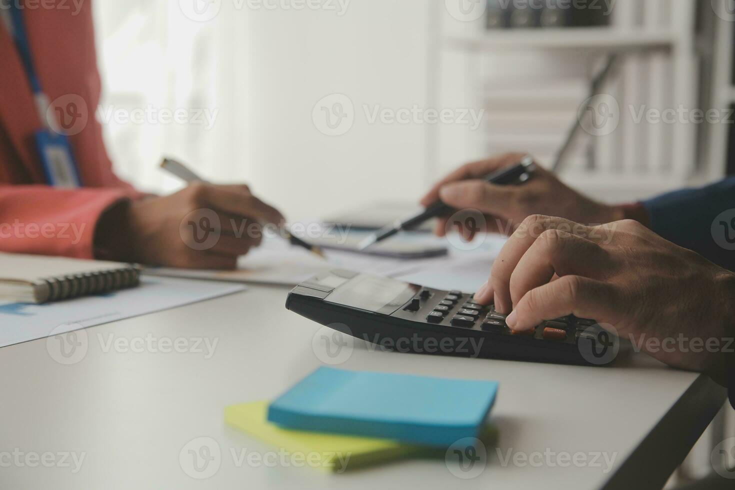 Close up Business woman using calculator and laptop for do math finance on wooden desk, tax, accounting, statistics and analytical research concept photo