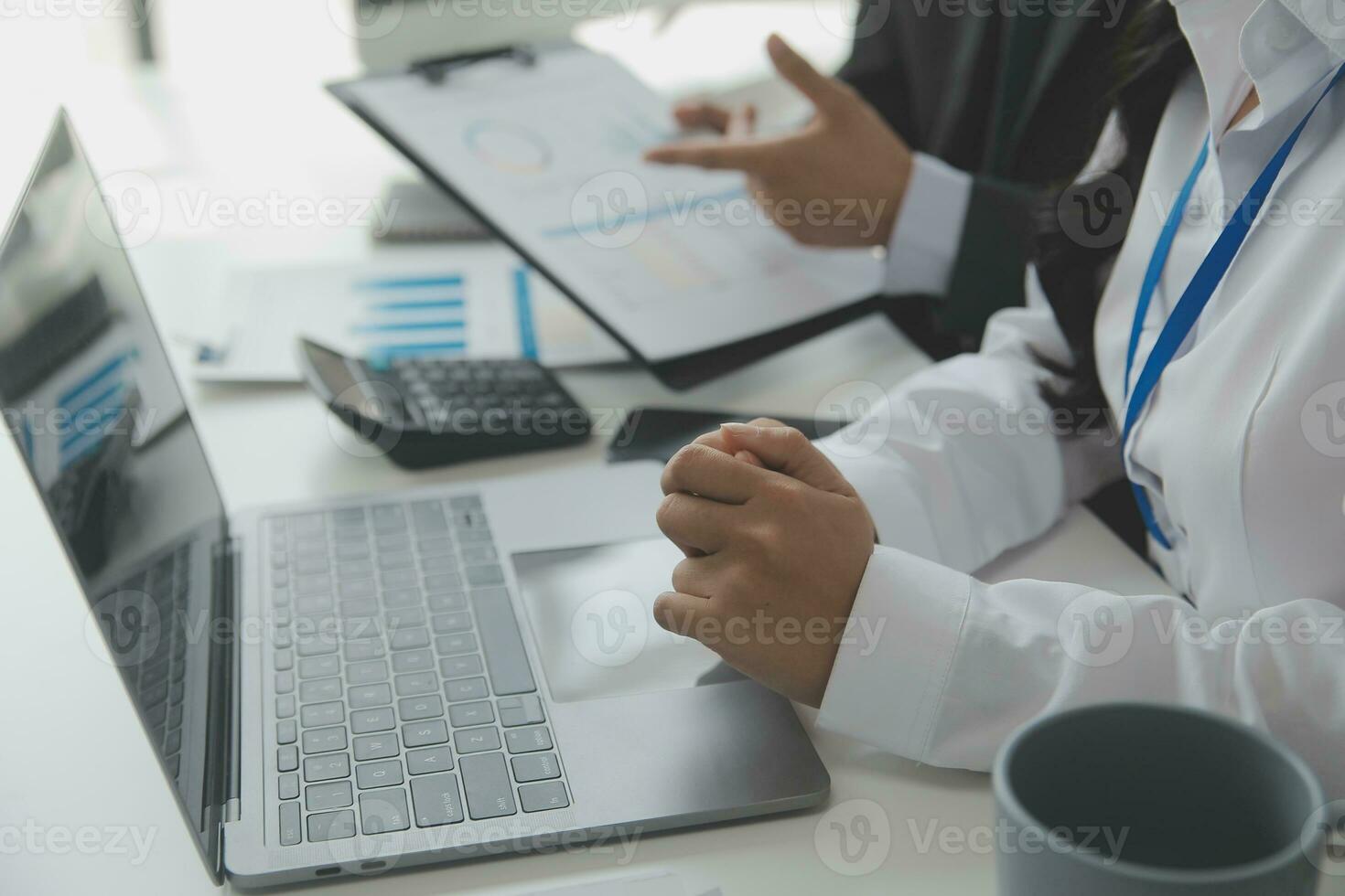 Close up Business woman using calculator and laptop for do math finance on wooden desk, tax, accounting, statistics and analytical research concept photo