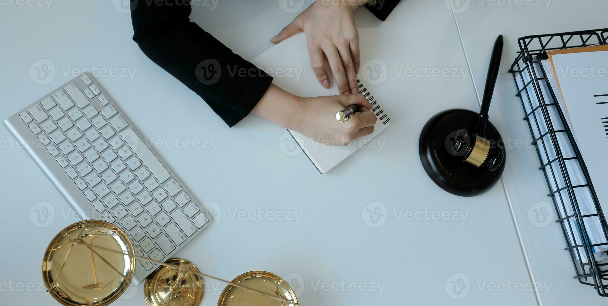 Male lawyer working with contract papers and wooden gavel on tabel in courtroom. justice and law ,attorney, court judge, concept. photo