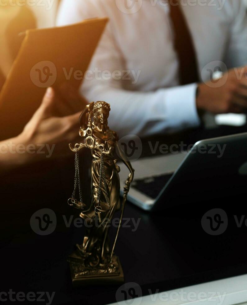 Judge gavel with Justice lawyers having team meeting at law firm in background. Concepts of law. photo
