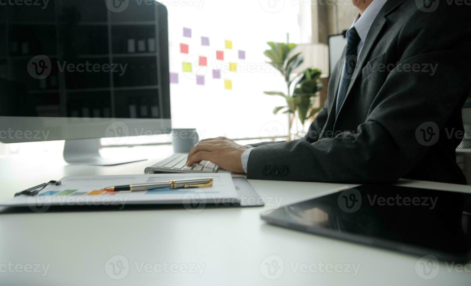 Close up Business woman using calculator and laptop for do math finance on wooden desk, tax, accounting, statistics and analytical research concept photo