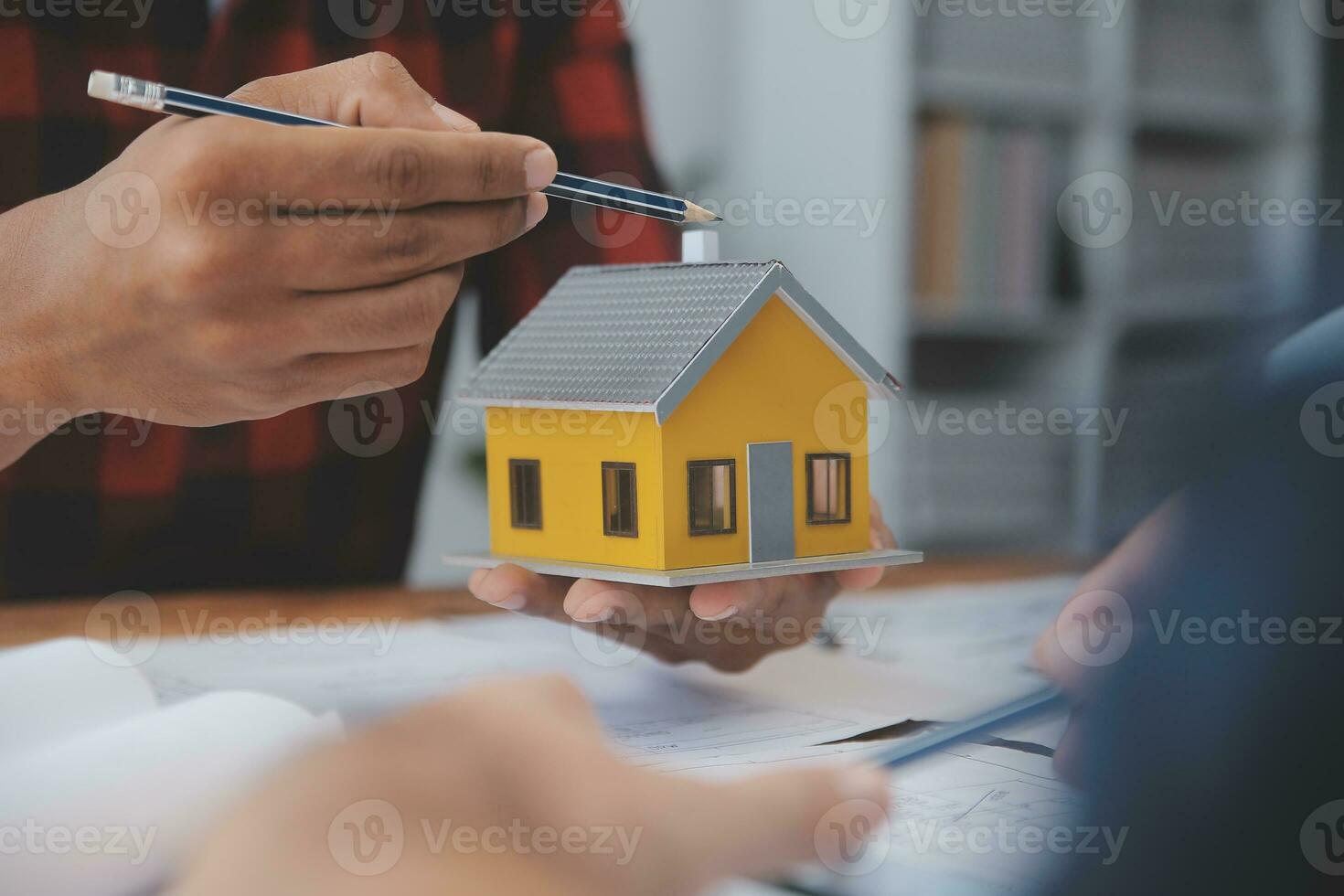 Close up of civil male engineer asian working on blueprint architectural project at construction site at desk in office. photo