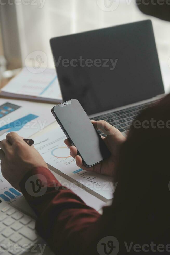 Close up Business woman using calculator and laptop for do math finance on wooden desk, tax, accounting, statistics and analytical research concept photo