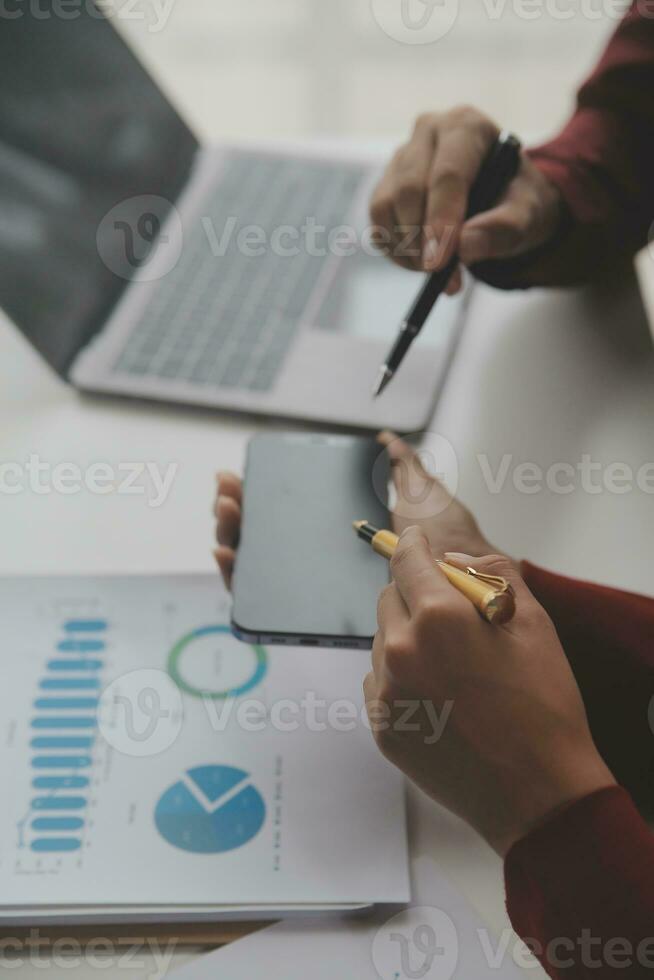 Close up Business woman using calculator and laptop for do math finance on wooden desk, tax, accounting, statistics and analytical research concept photo