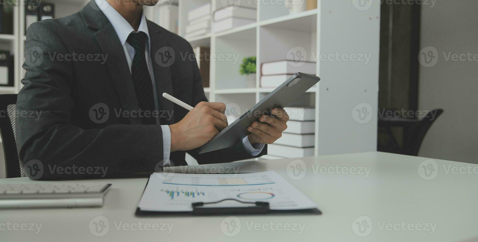 Close up Business woman using calculator and laptop for do math finance on wooden desk, tax, accounting, statistics and analytical research concept photo