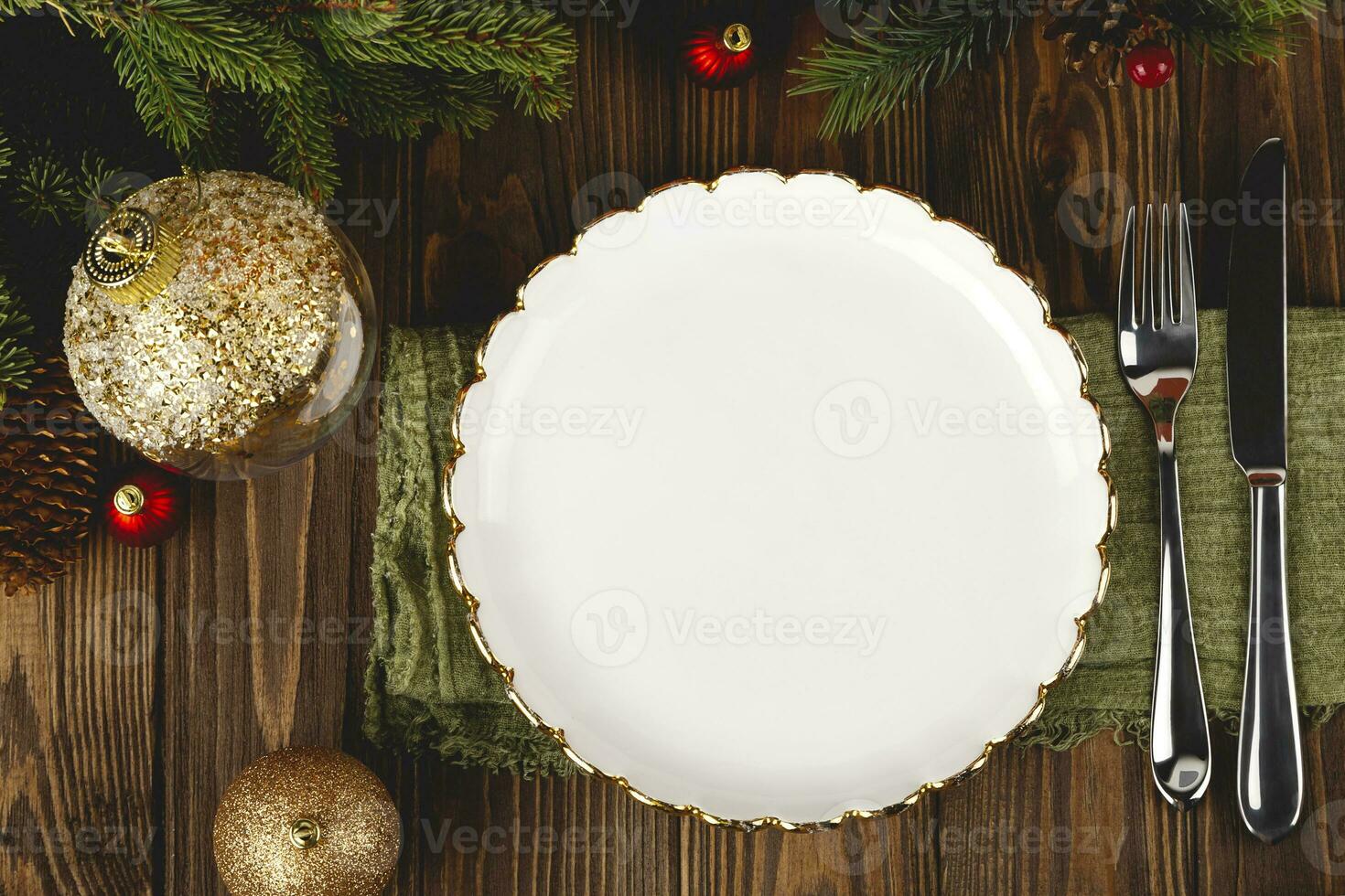 Empty white plate mock up at served Christmas table among decorations. Top view layout. photo