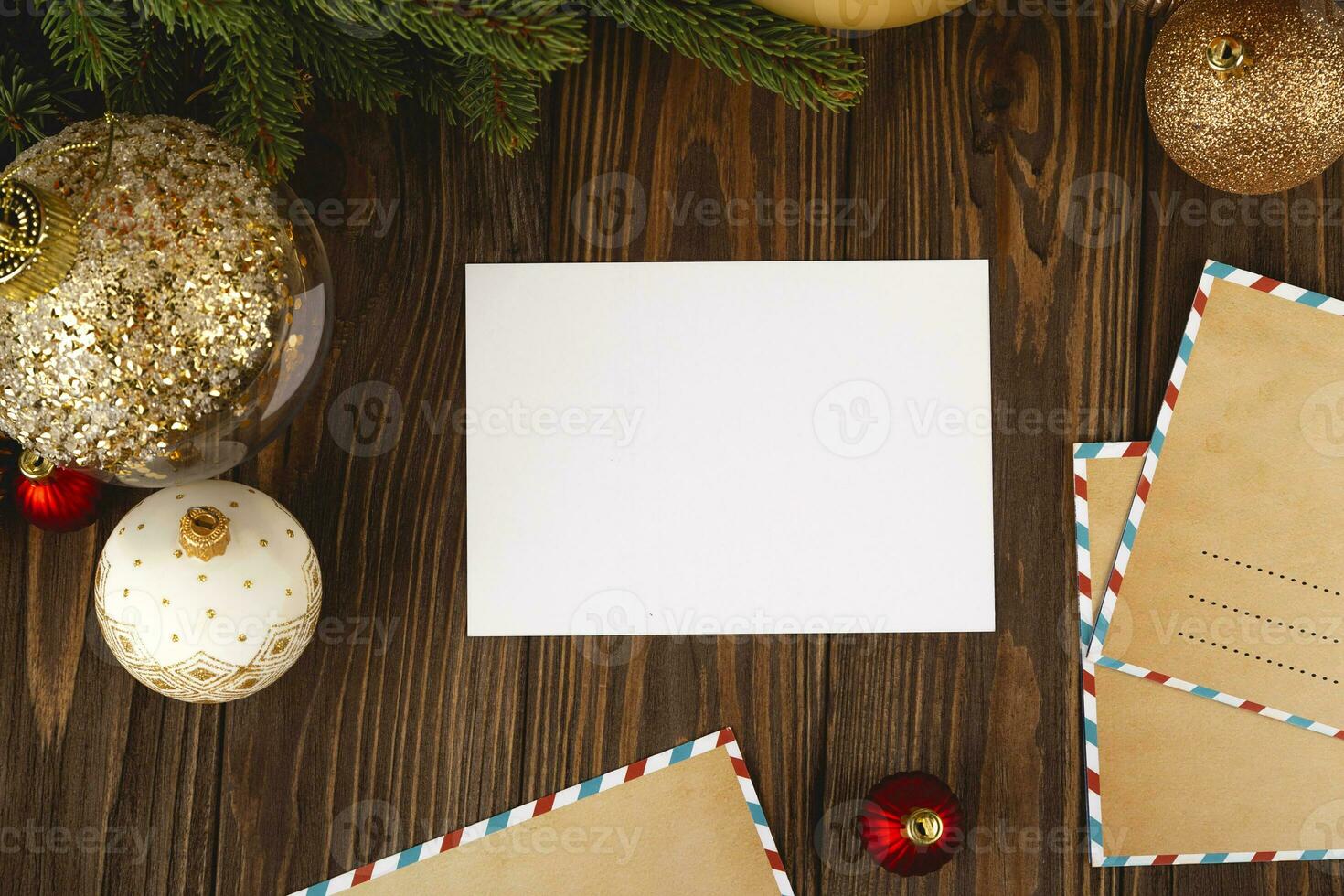 Christmas card mockup. White minimal empty postcard on wooden table with festive decorations and craft letters. photo