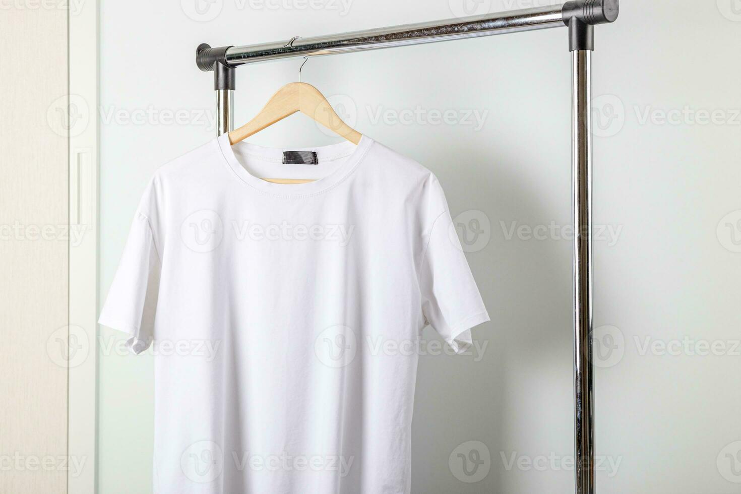 White t-shirt mockup on clothes hanger. Bella canvas mock up in minimal style. photo