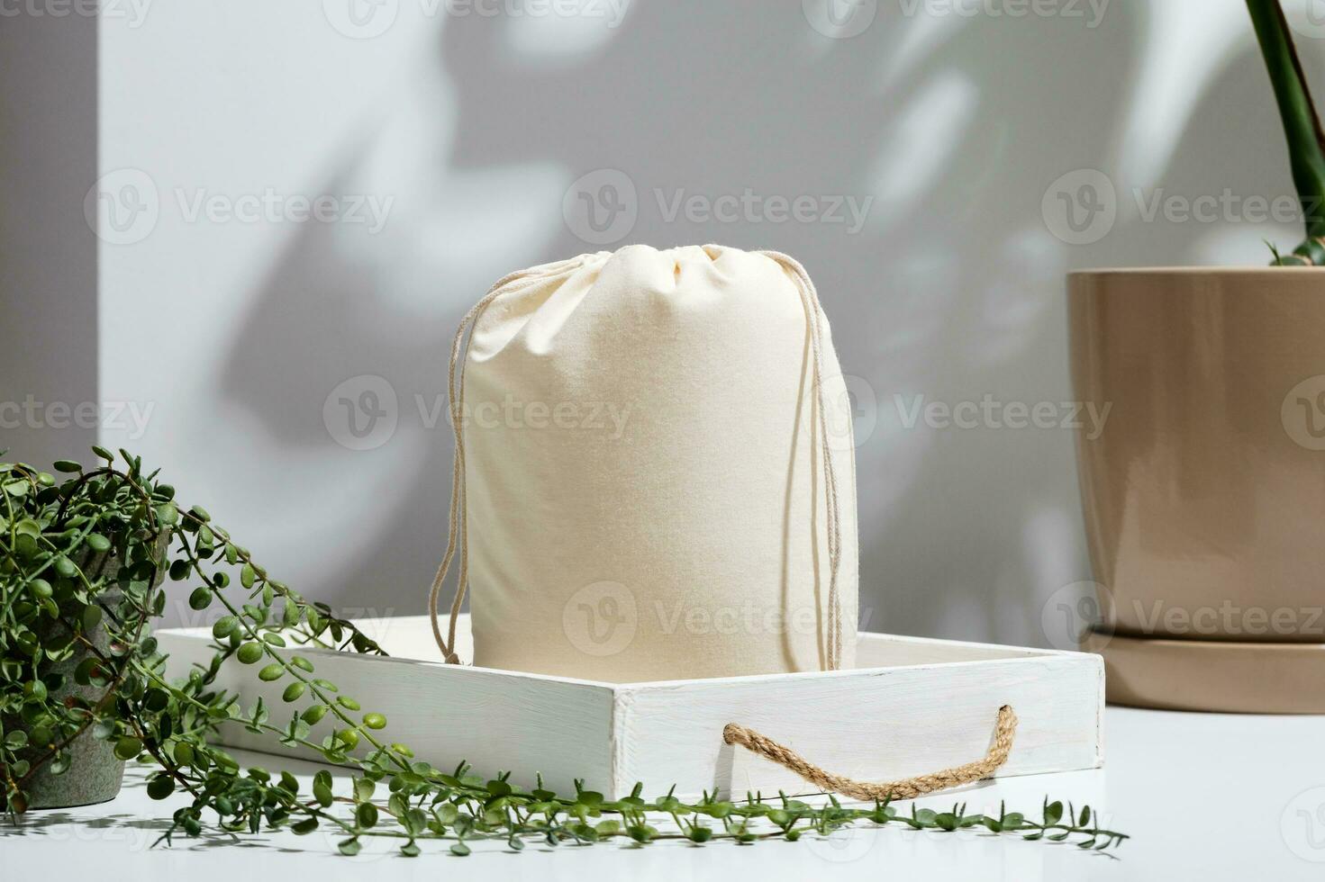 Reusable Eco bag mock up for zero waste shopping among green leaves and shadows. Minimal flat lay. photo
