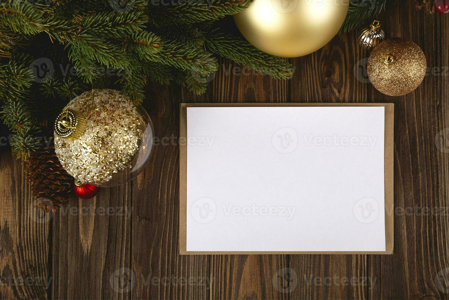 Christmas card mockup. White minimal empty postcard on wooden table with festive decorations and craft envelope. photo