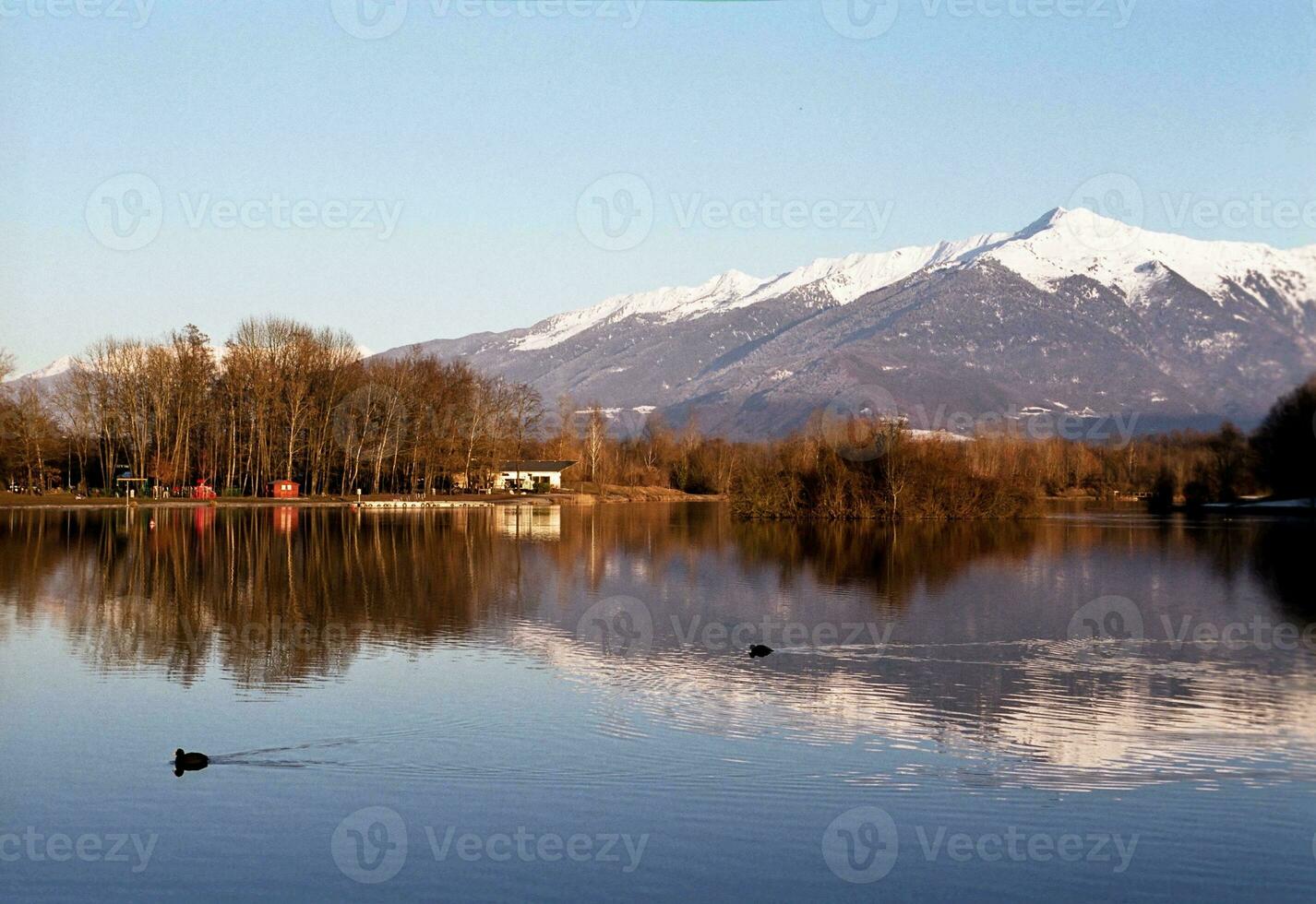 Serene Beauty Blue Lake in Savoie with Snow Capped Mountains photo