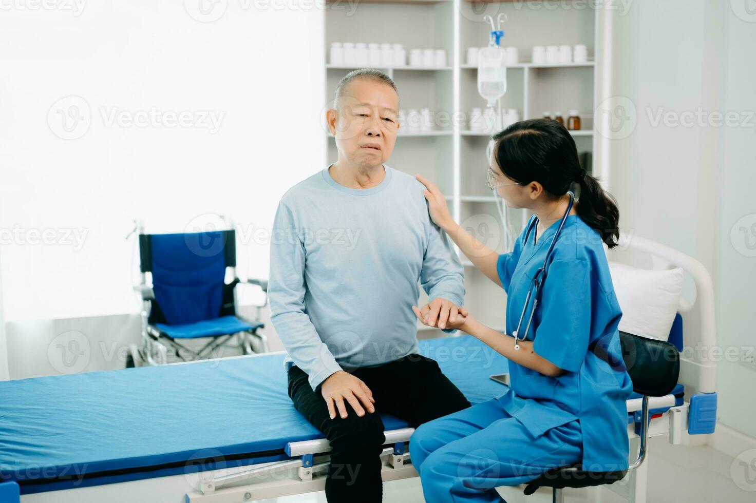 Asian Senior man being examined by a doctor in background photo