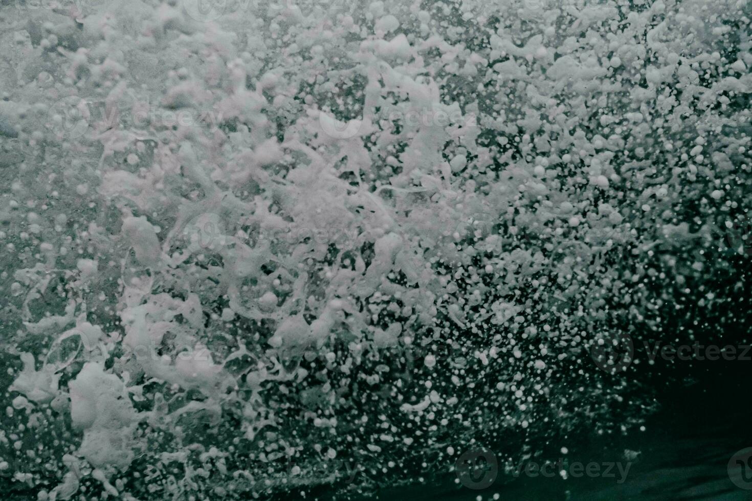 a close up of a wave crashing into the ocean photo