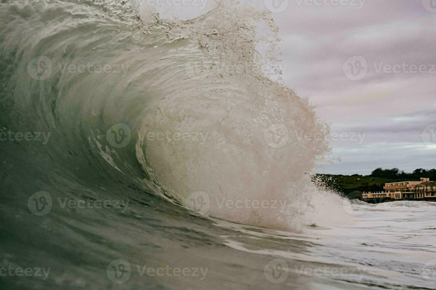 a large wave breaking on the shore photo