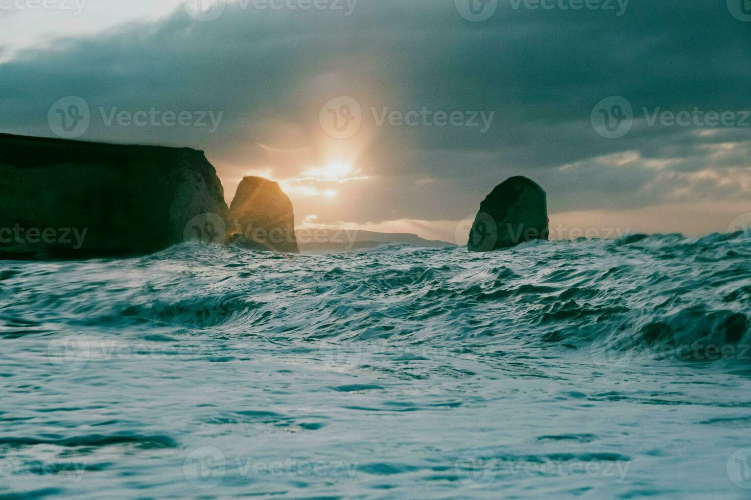 sunset over the sea at the beach photo