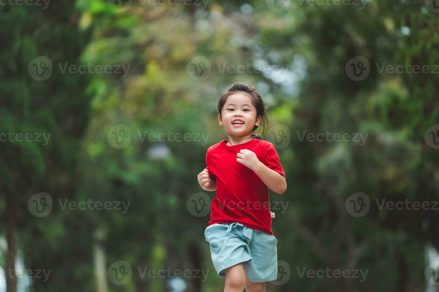 Happy baby asian girl smiling. little girl running and smiling at sunset happy baby girl smiling. little baby running at sunset. cute baby running at playground garden. photo