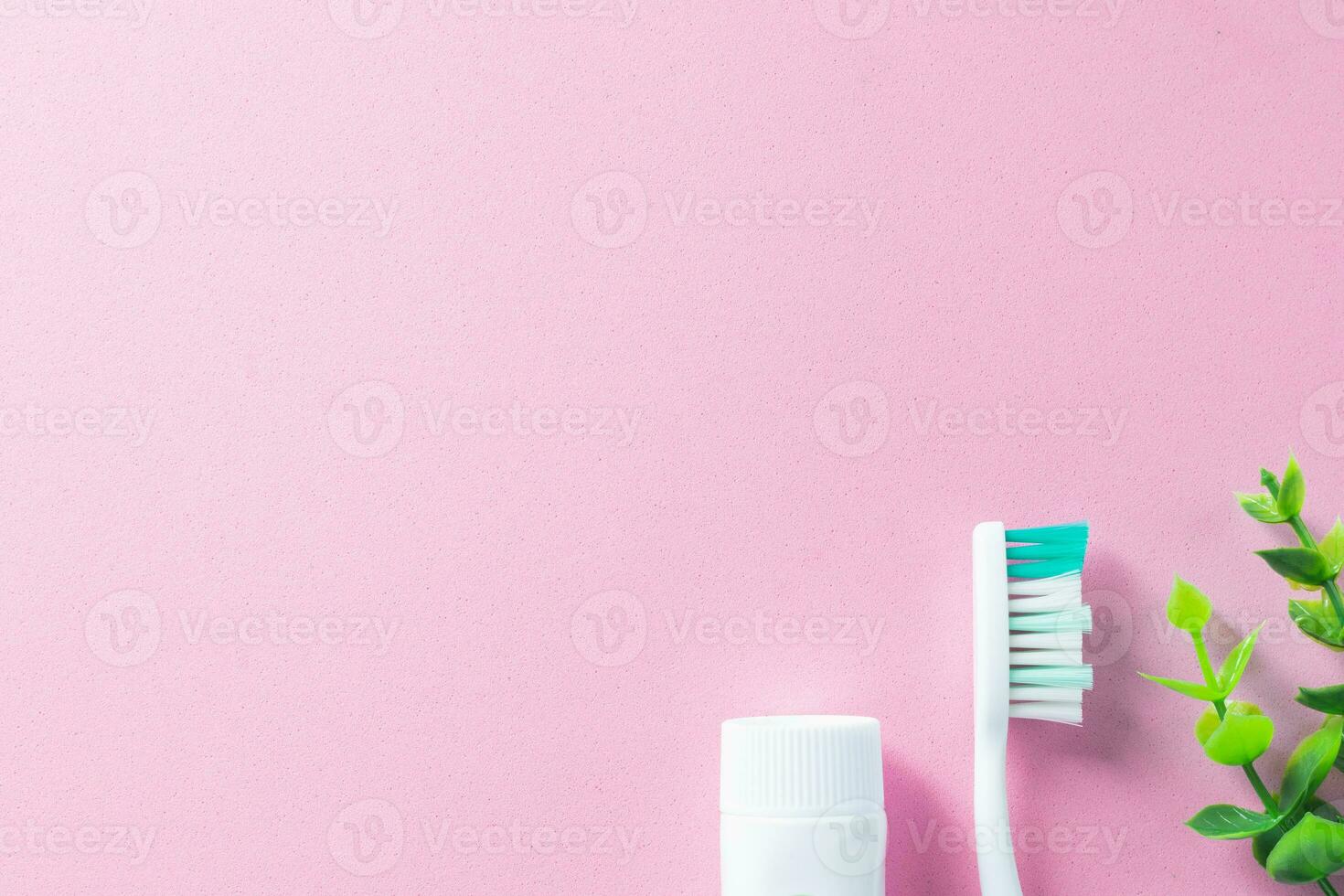 Pastel pink background with cleaning tools for oral and dental health care such as toothbrush and toothpaste. Lifestyle and daily routine for a healthy mouth and teeth. photo