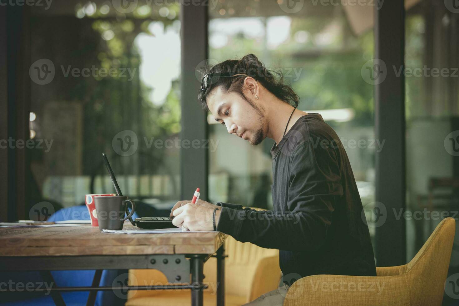 left handed freelance man write project in home working office photo