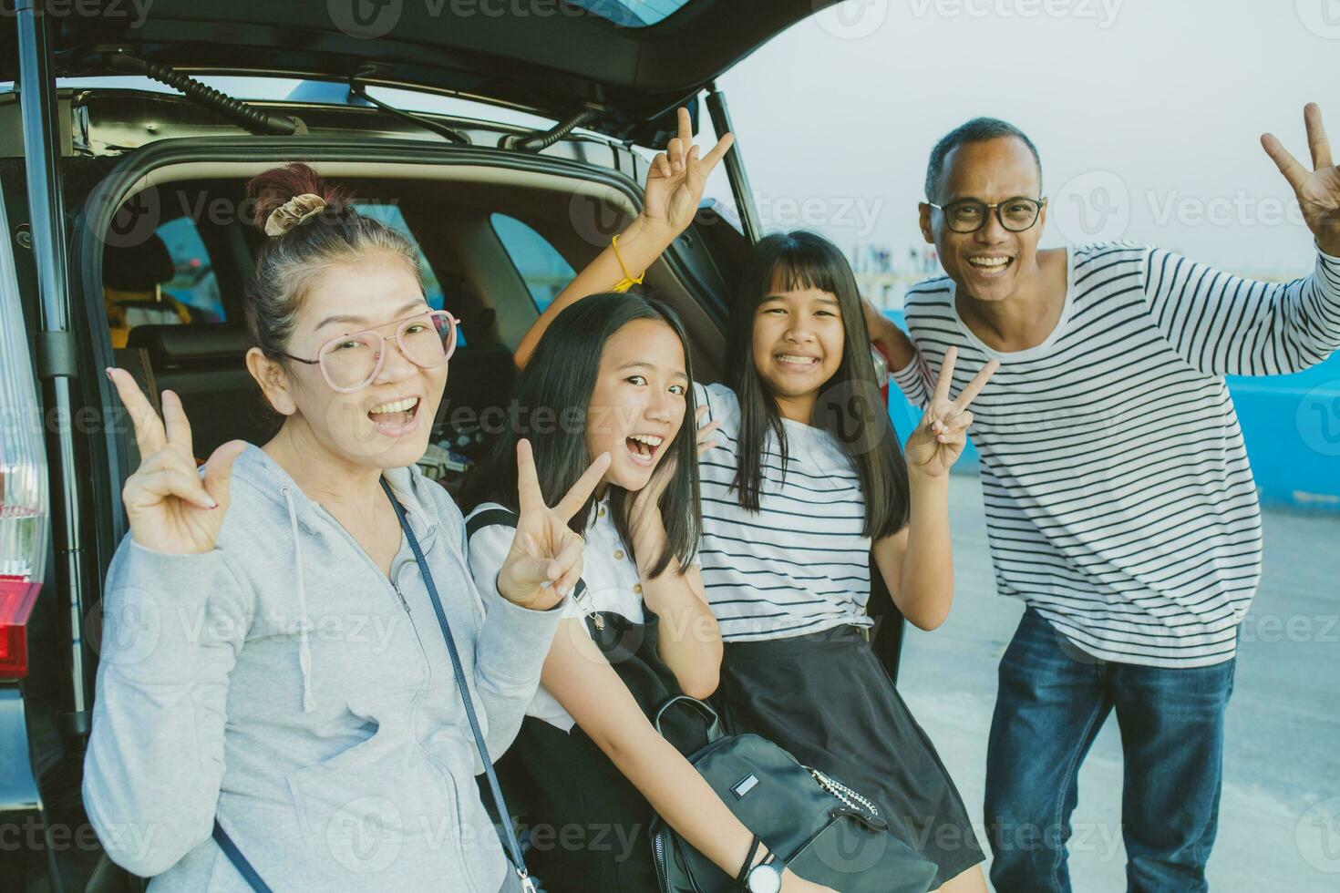 happiness emotion of asian family taking a photograph at vacation traveling destination photo