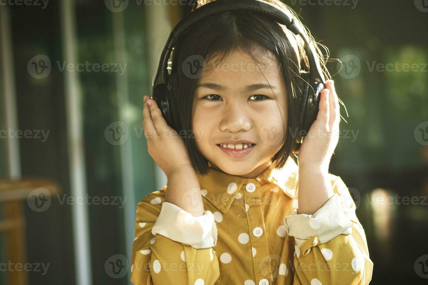 happiness face of asian children listening music in head phone photo